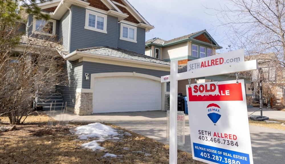 Calgary, Alberta, Canada. March 24, 2022. A REMAX Realtor Sign of a Sold property during winter..jpg