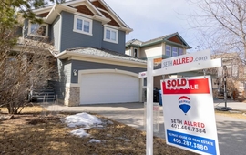 Calgary, Alberta, Canada. March 24, 2022. A REMAX Realtor Sign of a Sold property during winter..jpg
