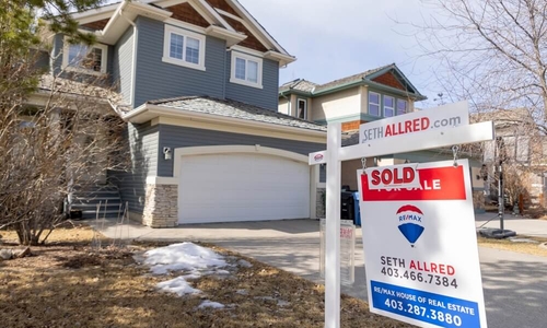 Calgary, Alberta, Canada. March 24, 2022. A REMAX Realtor Sign of a Sold property during winter..jpg
