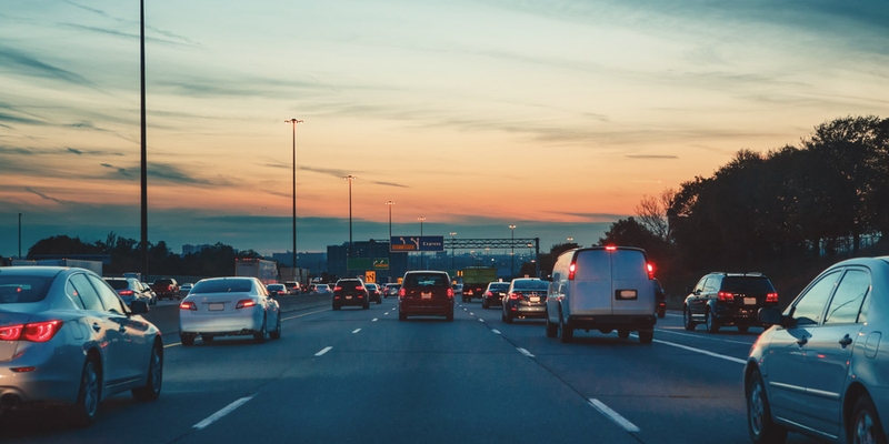 cars driving on Ontario highway just after sunset