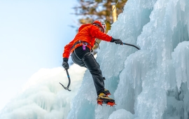 man with climbing equipment, ice axes and rope, hiking at a frozen waterfall (1).jpg