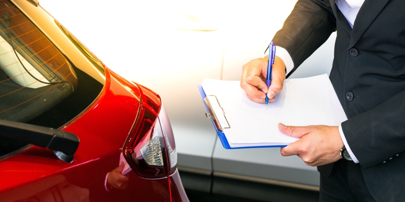 man writing on notepad or book, paper with car on wood background..jpg
