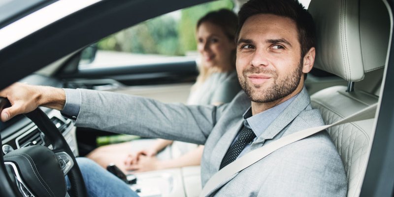 Professional couple in grey vehicle