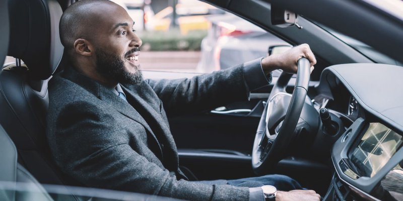 A man driving in his modern car