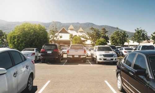 An empty parking spot in a crowded parking lot