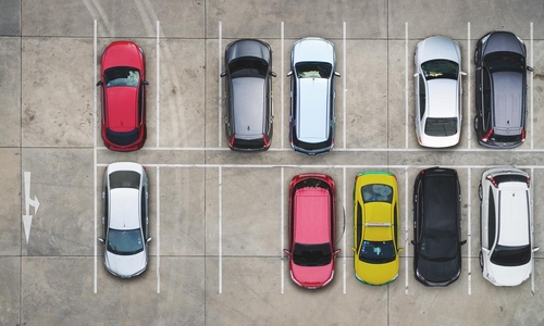 An aerial view of brightly coloured cars in a parking lot