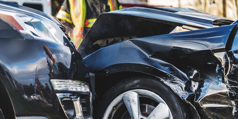 A close up view of damage to two black vehicles
