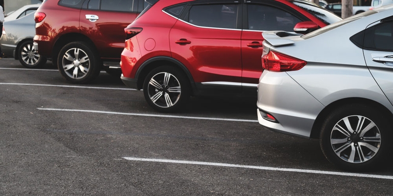 Red and silver cars parked in a diagonal row