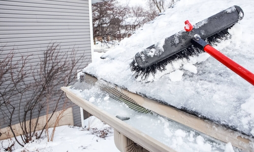 utters with ice dam and broom for raking snow off of a roof.jpg