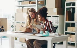 Women, tablet and teamwork for office logistics, package and e commerce checklist with stock of online shop. Small business people or seller with digital tech, box and clipboard for website order.jpg